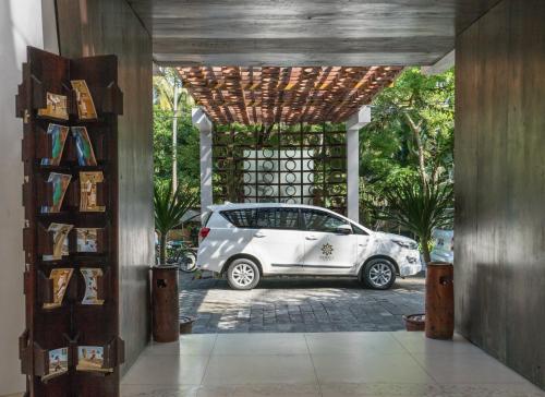 a white car parked in a parking lot at Svarga Resort Lombok in Senggigi 