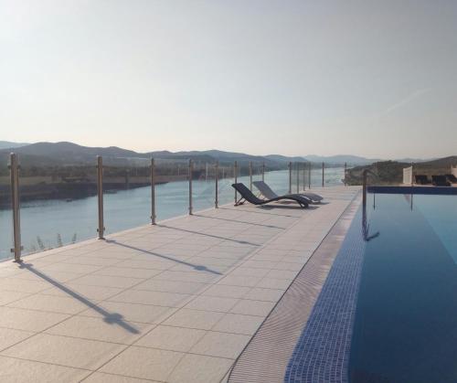 a swimming pool with a view of the water at Hotel Panorama in Šibenik