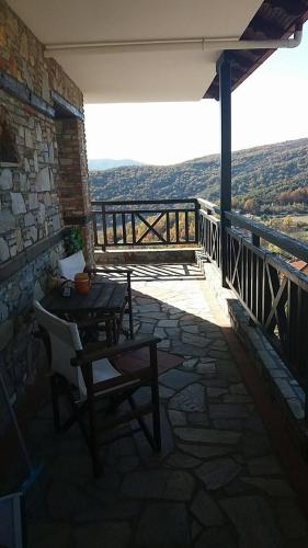 a patio with a table and chairs on a balcony at Guesthouse Kastro in Edessa