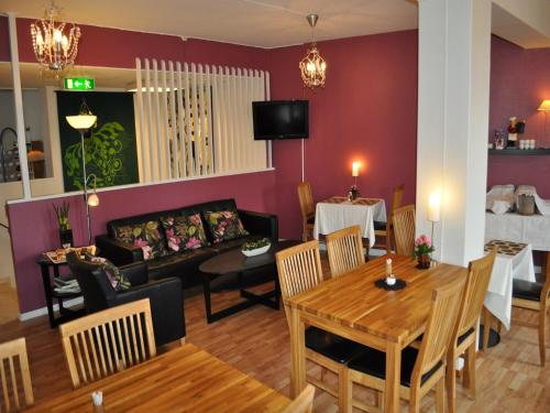 a living room with a couch and a table at Hotell Linnéa in Ljungby