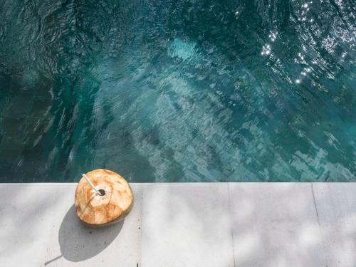 a donut sitting next to a pool of water at Bingin Castaways in Uluwatu