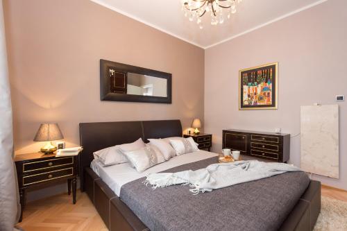 a bedroom with a large bed and two night stands at Apartmani Violic in Punat