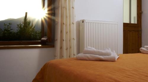a room with a bed with towels on it at Hotel Semeli in Goura
