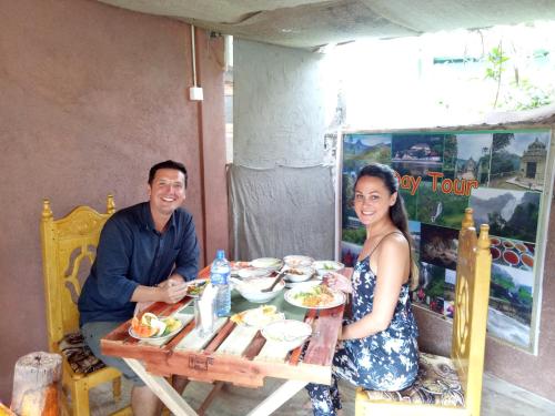 a man and a woman sitting at a table at Homeaway Homestay Hatton in Hatton