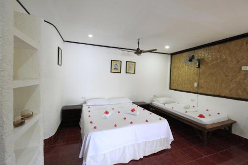a bedroom with a bed and a tub in it at Discovery Island Resort in Coron