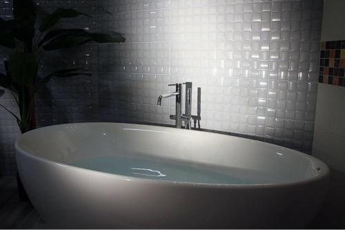 a white bath tub with a faucet in a bathroom at Relais Marlene in Avezzano