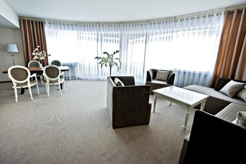 a living room with a couch and chairs and a table at Hotel Prezydencki 4-star in Rzeszów