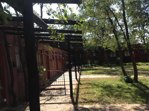 a wooden fence with a gate in a yard at Phokoje Bush Lodge in Selebi-Pikwe