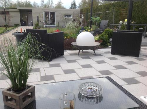 a patio with a table and a white orb on it at B&B Marianne in Binche