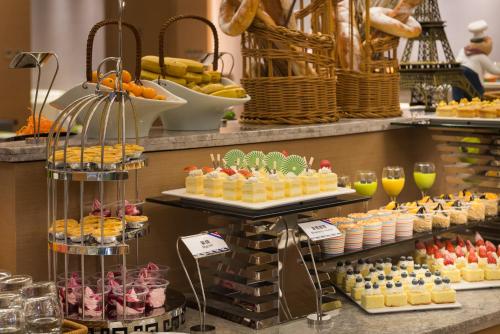 a buffet with many different types of desserts and drinks at Mercure Yantai Golden Beach in Yantai