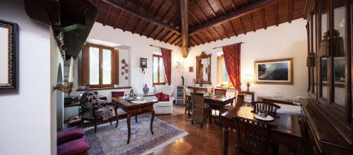 a living room with tables and chairs and a dining room at Villa Irene in Magione