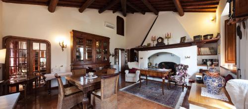 a living room with a table and a dining room at Villa Irene B&B in Magione