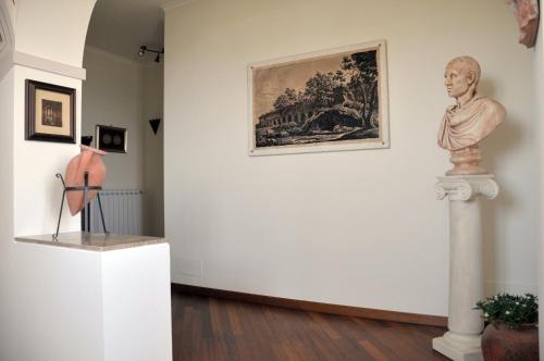 a museum exhibit with a statue and a painting on a wall at Antica Villa di Bruto in Tivoli