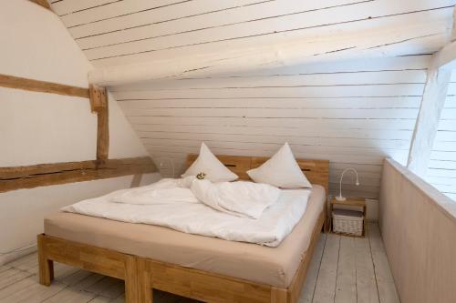 מיטה או מיטות בחדר ב-Bellevue Maison de Greunebennet