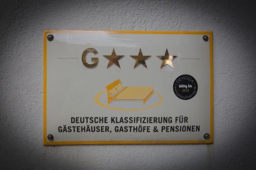 a sign on a wall with stars on it at Gasthof Im Kohl in Neuenrade