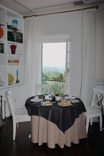 a table with food on it in a room with a window at Antica Villa di Bruto in Tivoli
