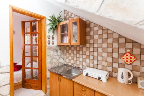 a kitchen with a sink and a counter top at Guest House Mara in Vela Luka