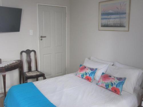 a bedroom with a bed with two pillows on it at 20 belladonna avenue Vredehoek Cape town in Vredehoek