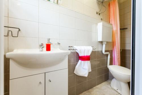a bathroom with a sink and a toilet at Guest House Mara in Vela Luka