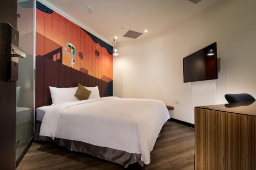 Tempat tidur dalam kamar di Merryday Hotel Banqiao