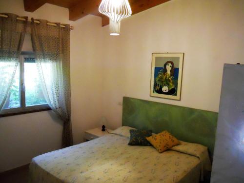 a bedroom with a bed and a window at Casa Anselmi in Portoferraio