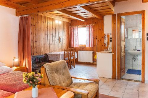 a living room with a couch and a dining room at ALina Apartmanház in Hévíz