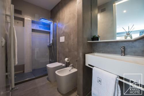 a bathroom with a toilet and a sink and a shower at B&B Rakel Home in Milazzo
