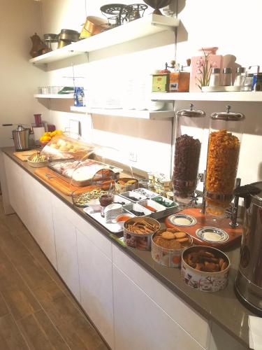 a buffet of food on a counter in a kitchen at Theresia in Riva del Garda