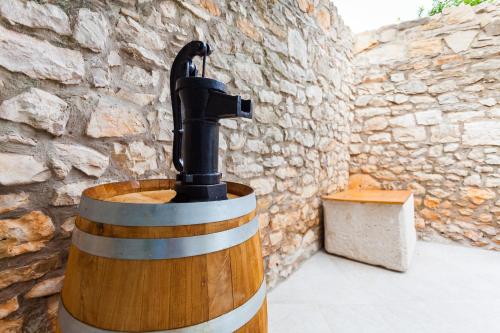 a statue of a bird sitting on top of a barrel at Guest House Mara in Vela Luka