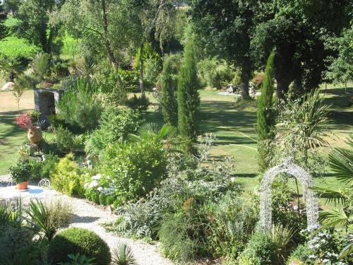a garden with a bunch of plants and trees at Le Clos Saint Fiacre in Carentoir