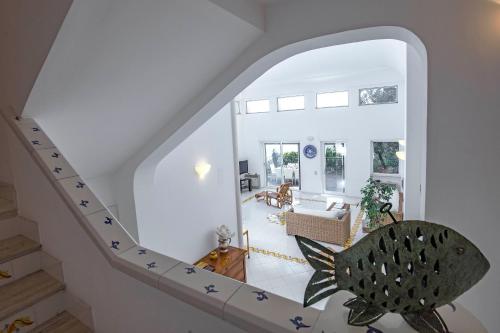 a staircase in a house with a living room at Villa dei Limoni con terrazza e discesa a mare in Erchie