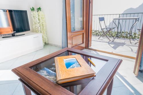 a wooden table with a book and pencils on it at Casa TerryB - il Monticello in Positano