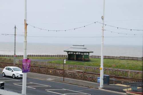 a car parked in front of a gazebo near the ocean at Brincliffe Hotel in Blackpool