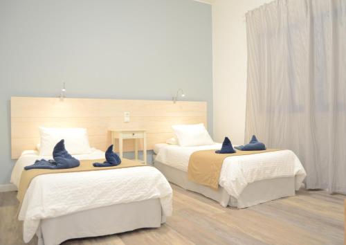 a bedroom with two beds with blue pillows on them at Apartamentos El Marinero - Salado in Caleta de Sebo