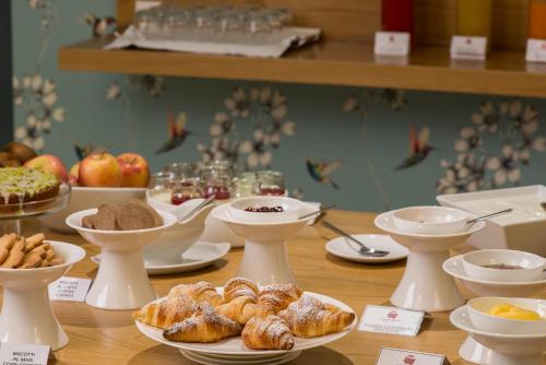 a table with croissants and other pastries and other foods at Alli Due Buoi Rossi in Alessandria