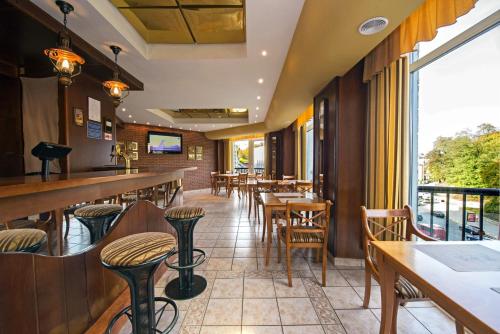 a restaurant with tables and chairs and a bar at Готель Дніпро in Kyiv