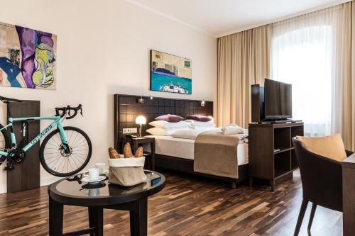 a hotel room with a bed and a bike at Hotel Sandwirth in Klagenfurt