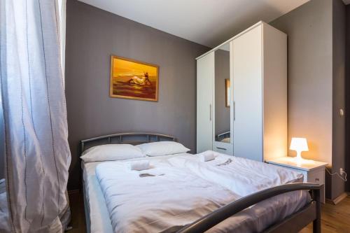 a bedroom with a large bed with a mirror at Holliday Home MaxDom in Sukošan