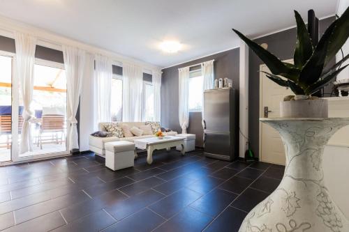 a living room with a couch and a table at Holliday Home MaxDom in Sukošan