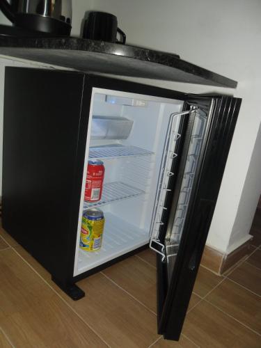 a refrigerator with its door open in a kitchen at Anjo Azul in Lisbon