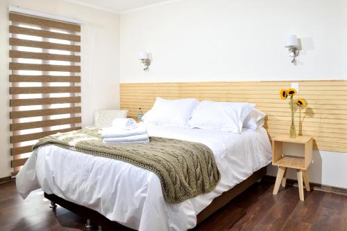 a bedroom with a large bed with a wooden headboard at Lagar Hotel Boutique in Molina