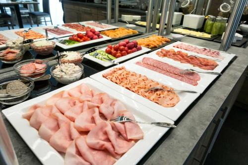 a buffet with many different types of meats and vegetables at Hotel Kern garni in Walddorf