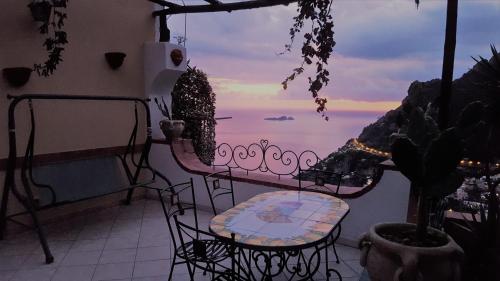 a balcony with chairs and a view of the ocean at Casa TerryB - il Monticello in Positano