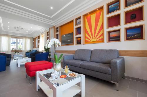 a living room with a couch and a table at Hotel O Sole Mio in SantʼAgata sui Due Golfi