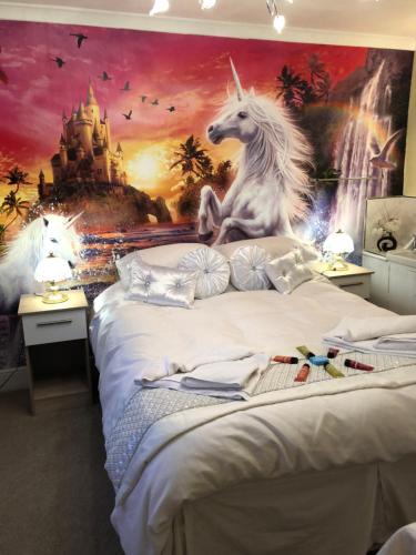 a bedroom with a mural of a unicorn and a castle at Jasmine House in Newquay