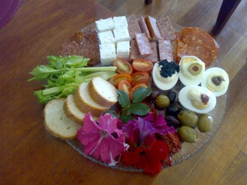 a plate of food on a wooden table at Swan Lake Guest House in Ventnor