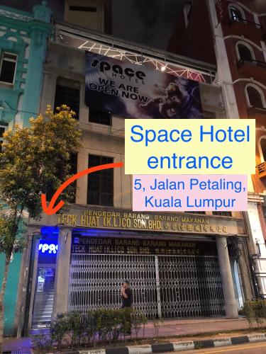 a sign for a space hotel entrance on a building at Space Hotel @ Chinatown Kuala Lumpur in Kuala Lumpur