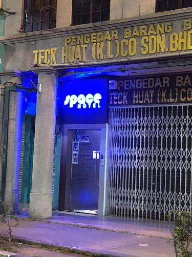 a sign on the front of a building with a door at Space Hotel @ Chinatown Kuala Lumpur in Kuala Lumpur