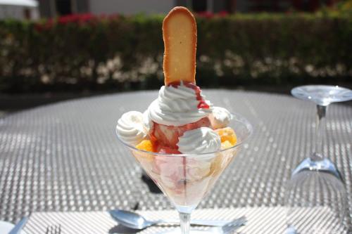 an ice cream sundae with a carrot sticking out of it at Pullman Lubumbashi Grand Karavia. in Lubumbashi