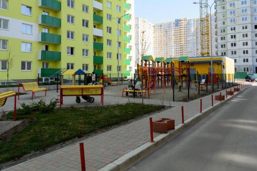 a playground with tables and benches in a city at Комфортні мині-апартаменти студіо на Юлії Здановської in Kyiv